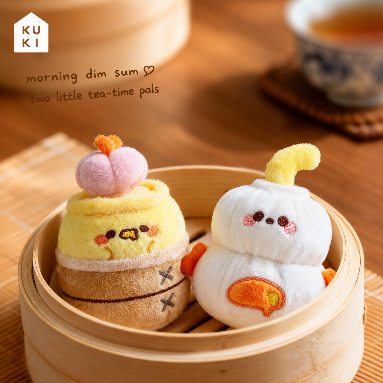 Two KUKI dim sum plush gel pens together in a bamboo steamer for morning tea