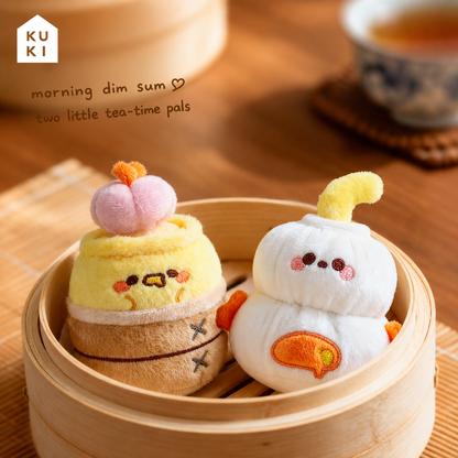 Two KUKI dim sum plush gel pens together in a bamboo steamer for morning tea
